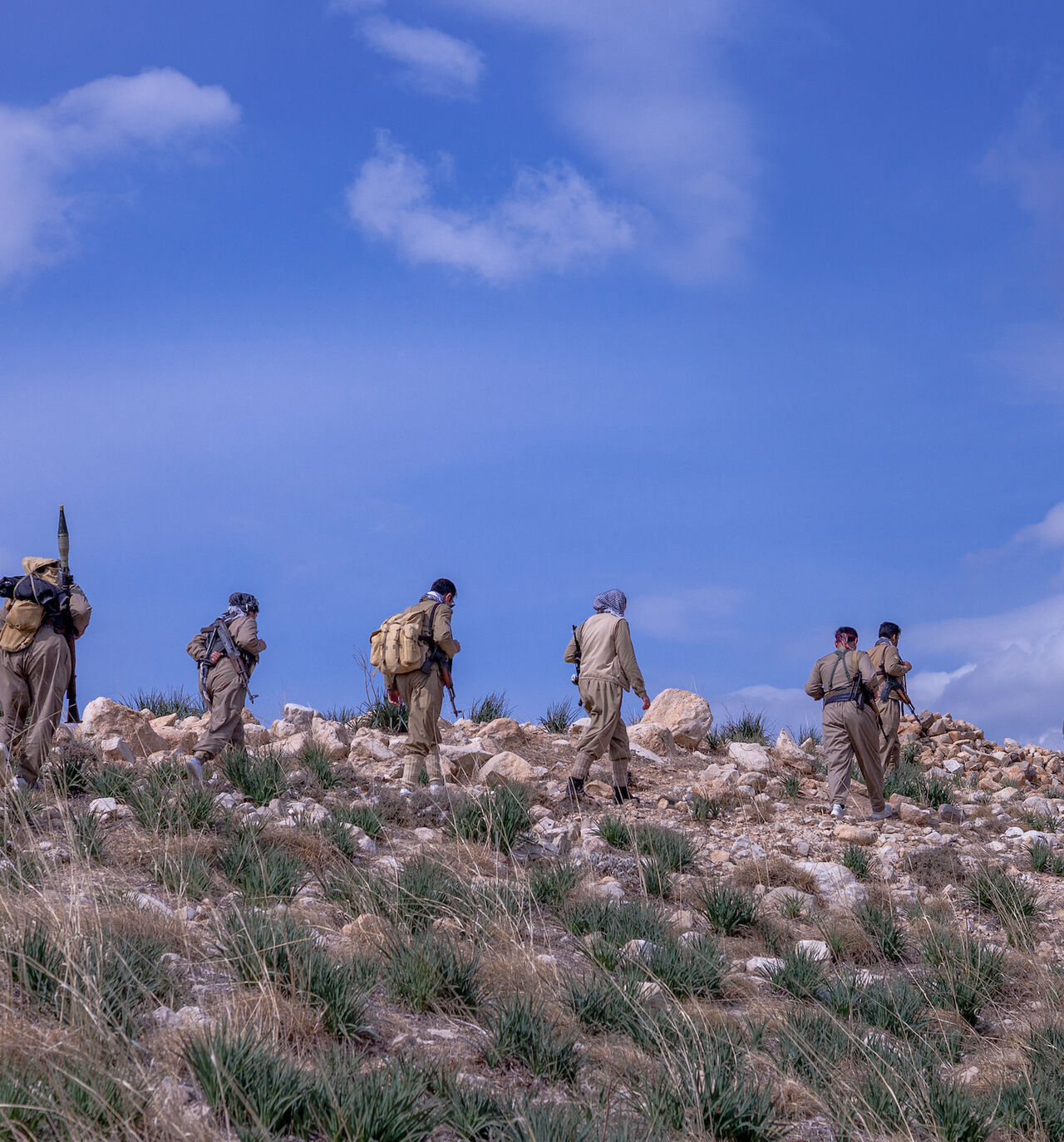 A group of Peshmergas of the Democratic Party of Iranian Kurdistan (PDKI) walks during military training near one of their bases in the Kurdistan Region of Iraq, on March 1, 2025. 
