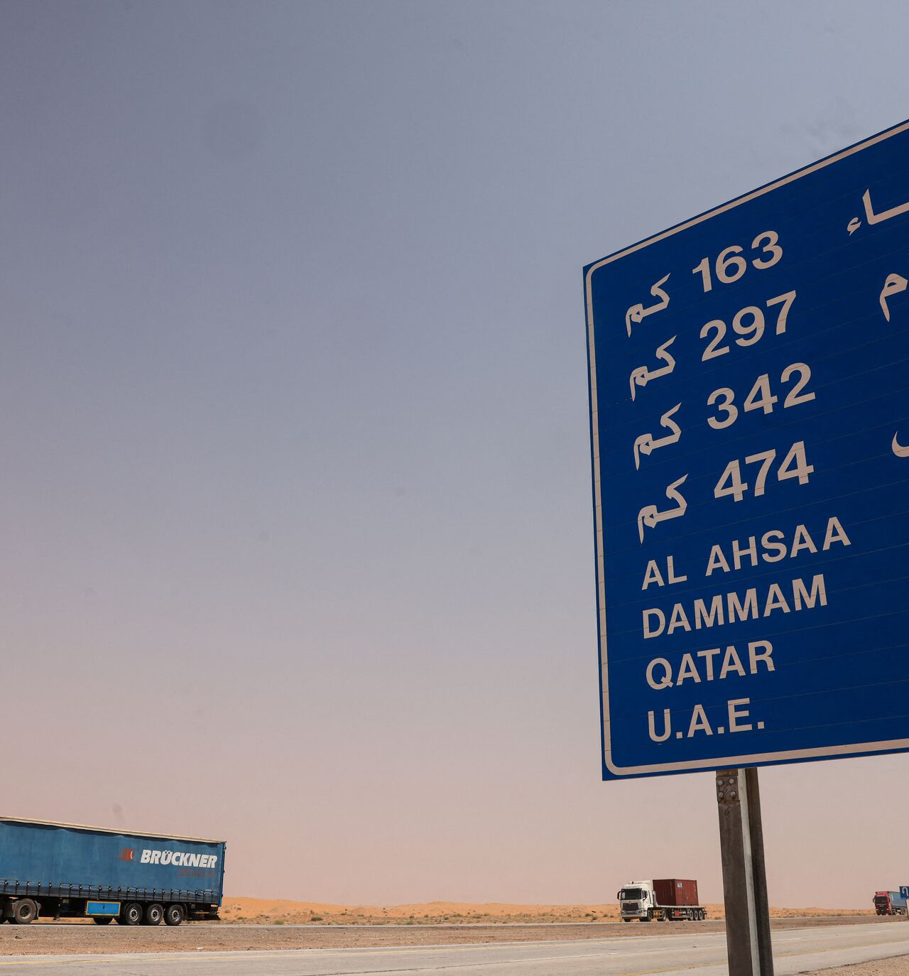 Lorries roll along the highway between Riyadh and al-Ahsa, some 200 kilometers east of the Saudi capital, on March 15, 2026. The war sparked by US-Israel strikes on Iran on February 28 has sparked chaos on global markets, and sent the price of oil soaring after the Islamic republic imposed control by force over the crucial artery. (Photo by Fayez NURELDINE / AFP via Getty Images) /