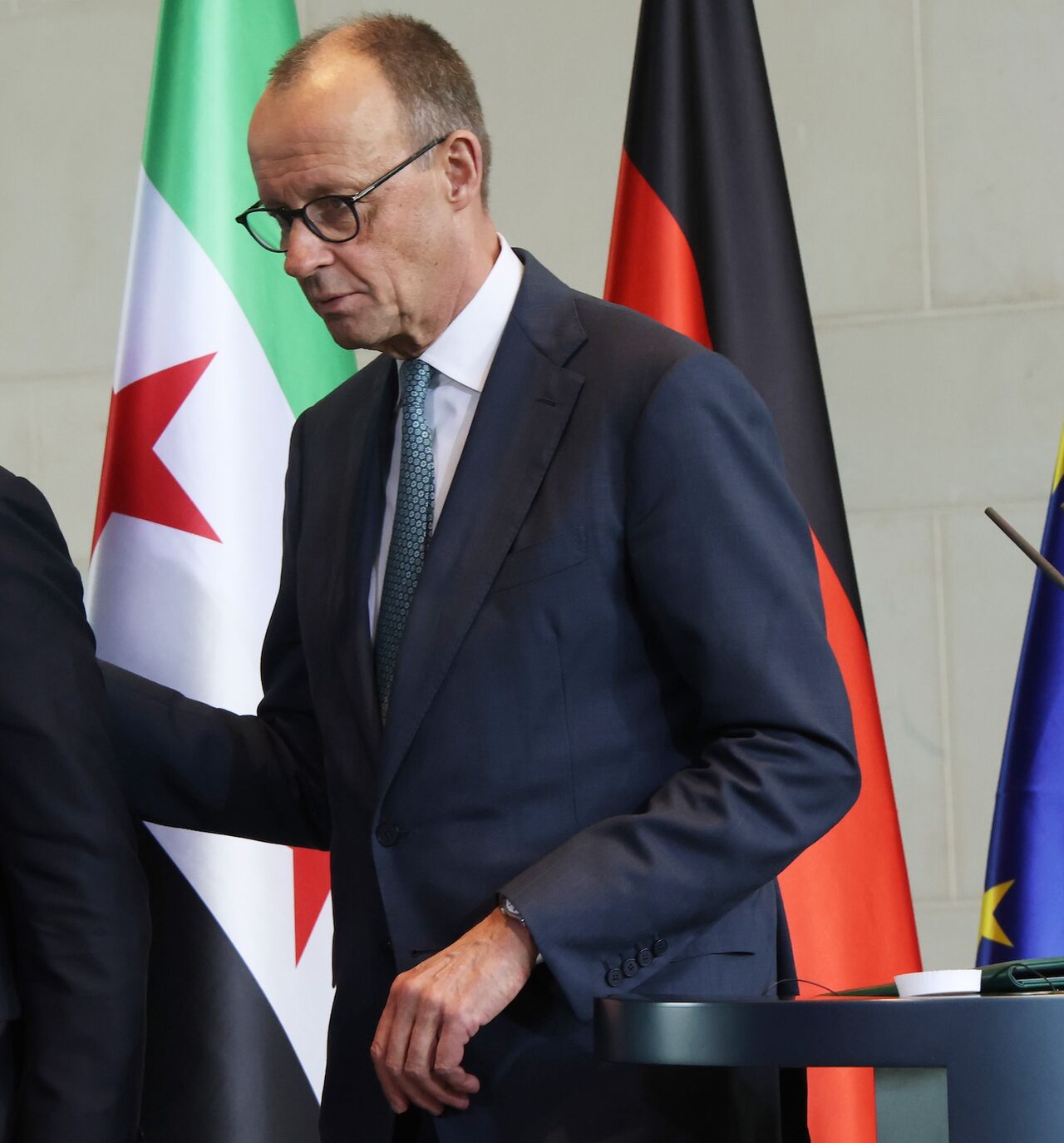 German Chancellor Friedrich Merz (R) and Syrian President Ahmed al-Sharaa depart after speaking to the media following talks at the Chancellery on March 30, 2026, in Berlin, Germany.