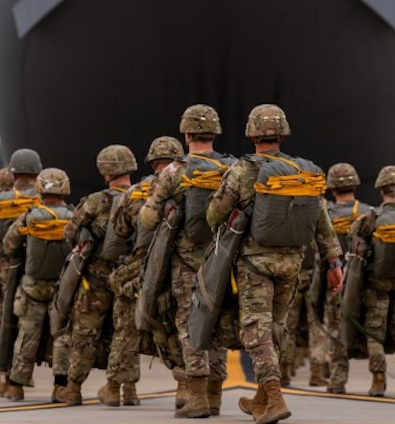 Paratroopers assigned to the 82nd Airborne Division walk to a C-17 Globemaster III before an airborne operation at Fort Bragg, North Carolina, March 13, 2025.