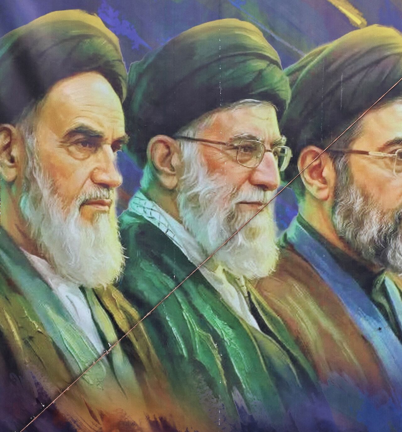 A woman walks past a banner featuring Iran's late supreme leaders, Ayatollah Ruhollah Khomeini (L) and Ayatollah Ali Khamenei (C), next to newly elected Supreme Leader Ayatollah Mojtaba Khamenei, in Tehran on April 19, 2026. 