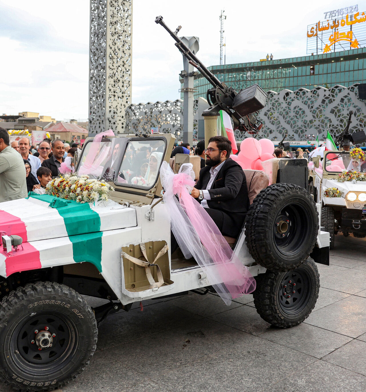 A bride and group couple rides in a military jeep arriving for a public mass wedding ceremony at Imam Hossein Square in Tehran on May 18, 2026. Iran said on May 18 that it had responded to a new US proposal aimed at ending the war, adding that diplomatic exchanges continue despite Iranian media reports describing Washington's demands as excessive. Washington and Tehran have been swapping proposals in an effort to end the conflict which the US and Israel launched on February 28, but they have held only a sin