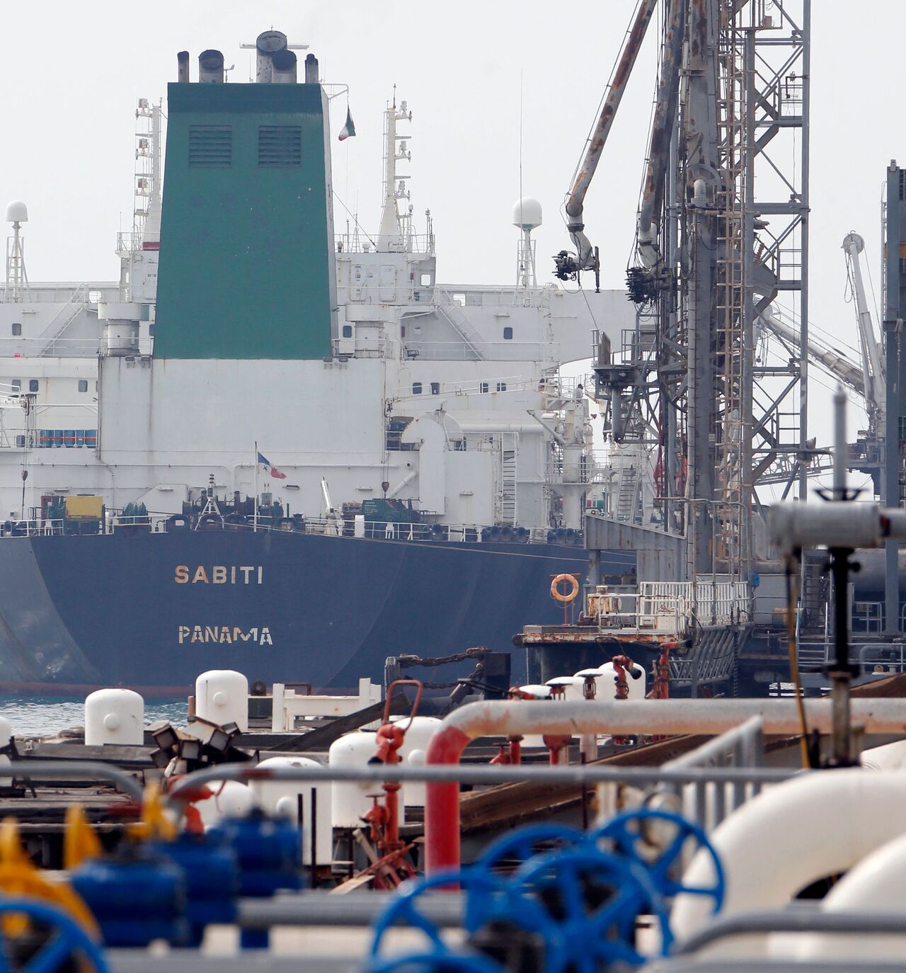 A picture taken on March 12, 2017, shows an Panamanian tanker docking at the platform of the oil facility in the Khark Island, on the shore of the Gulf. 