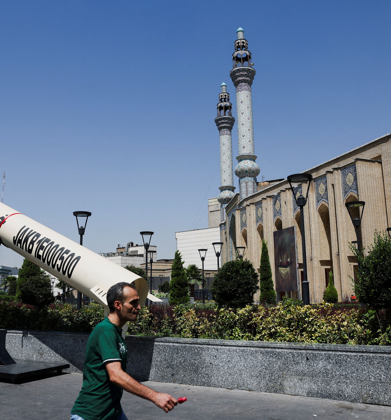 A man walks next to a symbolic mock-up of an Iranian missile, on a street in Tehran, Iran, June 11, 2026. Majid Asgaripour/WANA (West Asia News Agency) via REUTERS