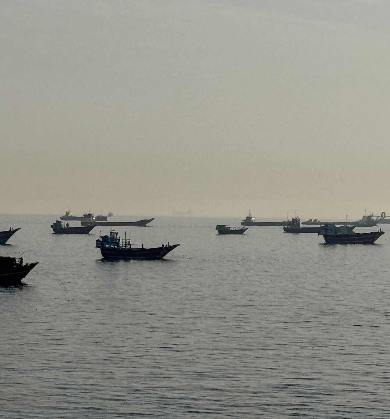 Vessels are seen anchored in the Strait of Hormuz, off the port city of Khasab on Oman's northern Musandam Peninsula, on May 17, 2026. 