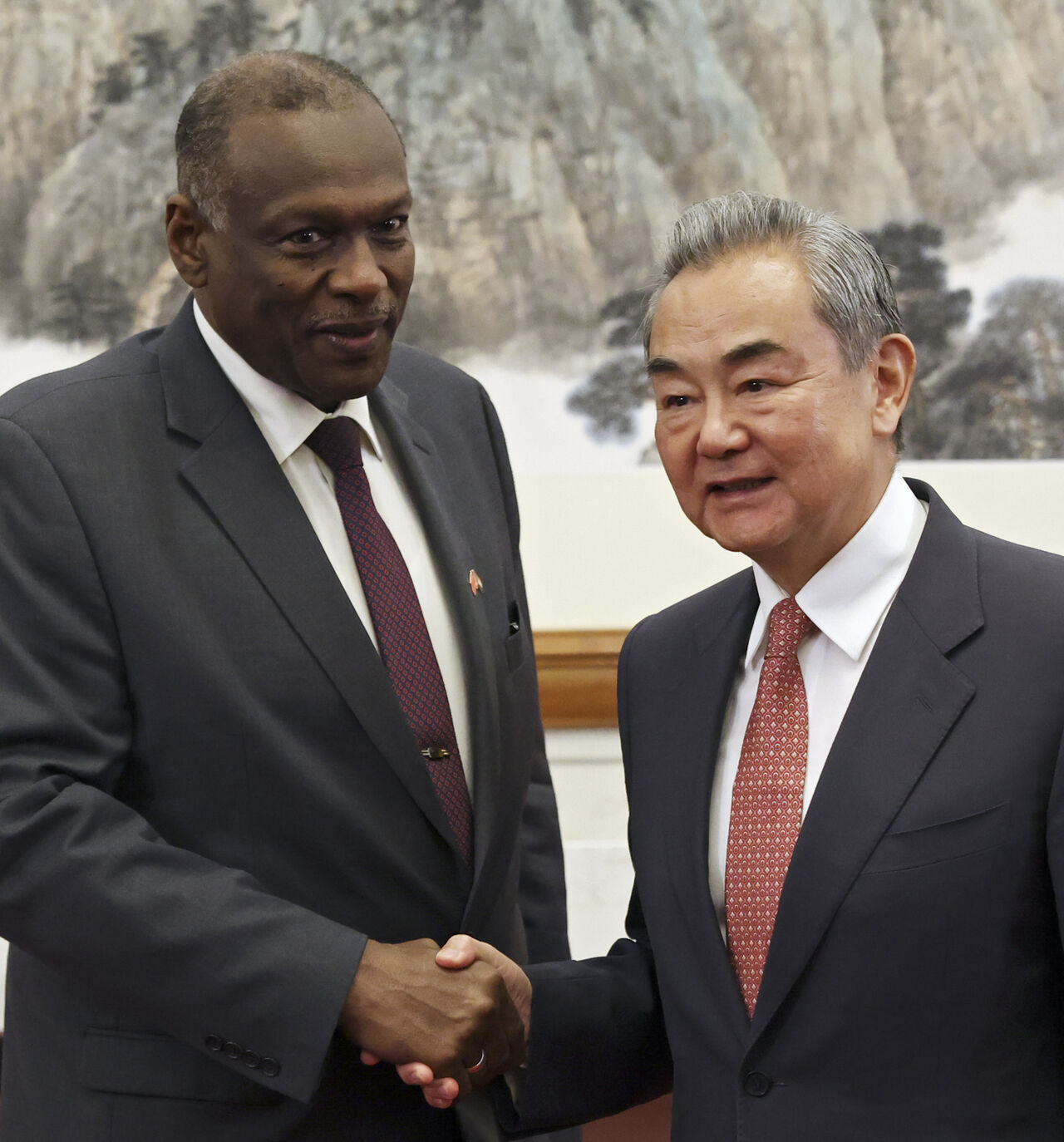 BEIJING, CHINA - MAY 14: Chinese Foreign Minister Wang Yi (R) shake hands with Omar Seddik, Sudan's newly appointed foreign minister before their meeting during the China-CELAC Forum at Diaoyutai State Guest House on May 14, 2025 in Beijing, China. The summit includes China's key Latin American trade partners, and comes as Beijing and Washington work on defusing a trade war. (Photo by Florence Lo - Pool/Getty Images)