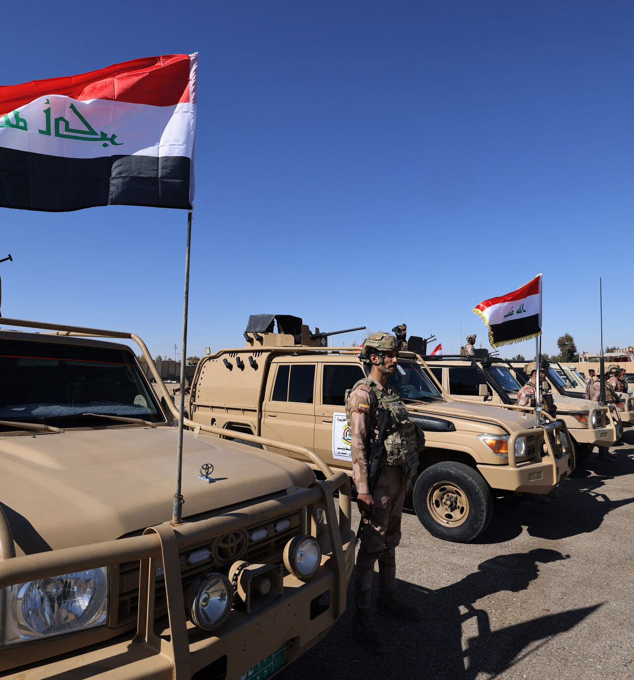 Iraqi soldiers from the new 'desert battalion' special forces stand next to military vehicles as the take part in a graduation ceremony, after months of training by the French military, at the Ain al-Asad air base in Anbar west of Baghdad on February 29, 2024. (Photo by Ahmad AL-RUBAYE / AFP) (Photo by AHMAD AL-RUBAYE/AFP via Getty Images)