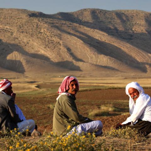 Displaced Iraqis from the Yazidi community, who fled violence between Islamic State (IS) group jihadists and Peshmerga fighters in the northern Iraqi town of Sinjar, sit in a field near a camp for internally displaced persons (IDP) in the Sharya area some 15 kilometres from the northern Iraqi city of Dohuk on May 20, 2015. 