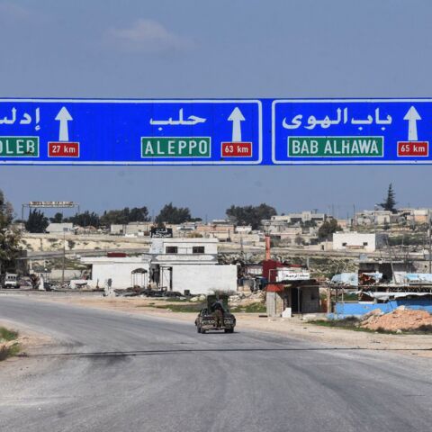 Syrians drive in the town of Saraqeb along the main Damascus-Aleppo (M5) highway in Syria's northwestern Idlib province on March 7, 2020, following a Russian-Turkish cease-fire deal. 