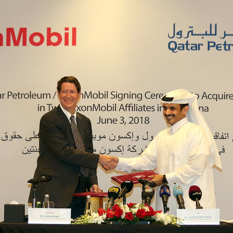Andrew Swiger, senior vice-president of Exxon (L) shakes hand with Saad Sherida Al-Kaabi, president and CEO of Qatar Petroleum after signing an agreement, Doha, Qatar, June 3, 2018.