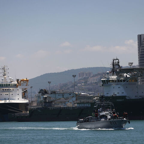 Cargo ships are moored along a dock at the port of Haifa, Israel, June 24, 2021.