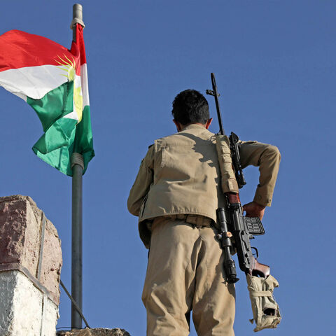 A Kurdish peshmerga fighter affiliated with the Iranian Kurdistan Democratic Party stands guard on top of a building following an Iranian cross-border attack in the town of Koye (Koysinjaq), Iraqi Kurdistan, Oct. 1, 2022.