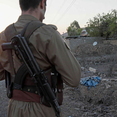 A Kurdish peshmerga fighter affiliated with the Iranian Kurdistan Democratic Party inspects the damage following an Iranian cross-border attack in the town of Koye (Koysinjaq), Iraqi Kurdistan, Oct. 1, 2022.