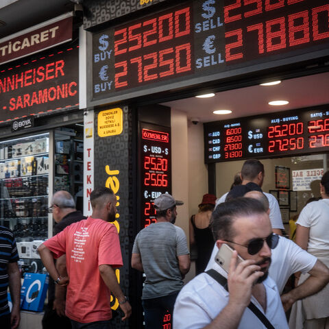 People wait to exchange money at a currency exchange shop on June 23, 2023 in Istanbul, Turkey. The Turkish Lira weakened to a record low of 25.74 against the dollar, a day after the central bank hiked interest rates from 8.5 percent to 15 percent in the first rate decision since the appointment of new central bank governor Hafize Gaye Erkan and the re-election of President Recep Tayyip Erdogan last month. (Photo by Chris McGrath/Getty Images)