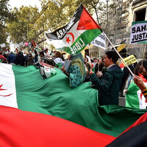 Activists for the independence of the Western Sahara wave flags and banners reading "Sahara: Only Pace!" during an annual protest organised by the state coordinator of associations of solidarity with the Sahara in Madrid on November 11, 2016 marking the 4th anniversary of the tripartite Madrid agreements demonstrators deem illegal. - The Western Sahara is a territory bordered by Morocco and Algeria and disputed by Spain and Morocco who both claiming sovereignty. (Photo by GERARD JULIEN / AFP) (Photo by GERA