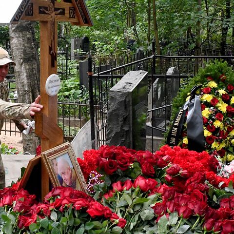 A man wearing camouflage visits the grave of Wagner private mercenary group chief Yevgeny Prigozhin, who was killed in a private jet crash in the Tver region last week, at the Porokhovskoye cemetery in Saint Petersburg on August 30, 2023. (Photo by Olga MALTSEVA / AFP) (Photo by OLGA MALTSEVA/AFP via Getty Images)