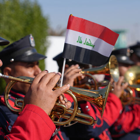 A military marching band plays outside during the first provincial council elections in a decade, at a polling station in the central city of Najaf, on December 18, 2023. The vote comes at a time of widespread disillusionment among the country's 43 million inhabitants, with endemic corruption eating away at the oil-rich nation. (Photo by Qassem al-KAABI / AFP) (Photo by QASSEM AL-KAABI/AFP via Getty Images)