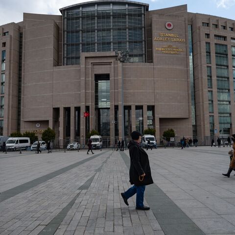 People walk past the Caglayan Justice Palace courthouse in Istanbul on March 21, 2022. - Turkey's leading activist Osman Kavala, who at the weekend marked his 1,600th day in prison without conviction, will appear in court on March 21, 2022, in a case that has strained Ankara's ties with the West. Kavala attends the court hearing via video link from his prison. 