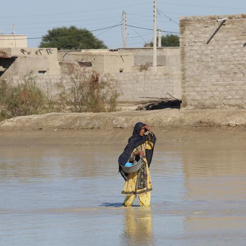 An Iranian woman walks through a flooded road on Jan. 13, 2020.