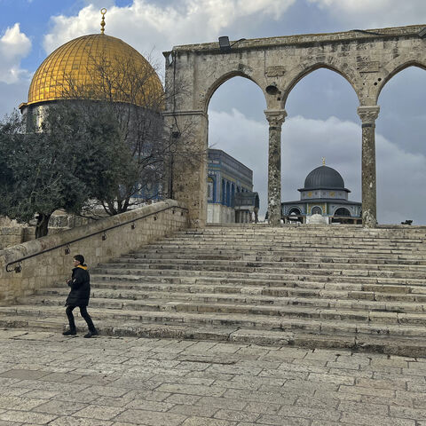 Palestinians walk past the Dome of the Rock at the compound of the Al-Aqsa mosque in the Old City of Jerusalem on Feb. 20, 2024.