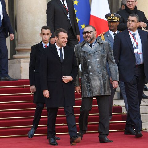 French President Emmanuel Macron (L) escorts King Mohammed VI of Morocco (C) and Crown Prince of Morocco, Moulay Hassan as they leave the Elysee palace on December 12, 2017 in Paris, following a lunch hosted by the French President as part of the One Planet Summit. The French President hosts 50 world leaders for the "One Planet Summit", hoping to jump-start the transition to a greener economy two years after the historic Paris agreement to limit climate change. (Photo by ALAIN JOCARD / AFP) (Photo by ALAIN 