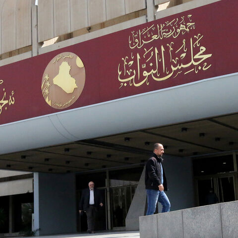 Iraqis stand outside parliament building, or Council of Representatives, in the Green Zone, Baghdad, Iraq, Feb. 27, 2020.