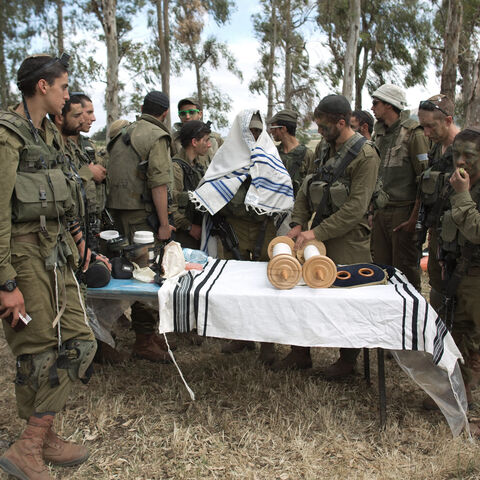 Israeli soldiers of the Netzah Yehuda Battalion hold morning prayers as they take part in their annual unit training in the Israeli annexed Golan Heights, near the Syrian border, May 19, 2014.