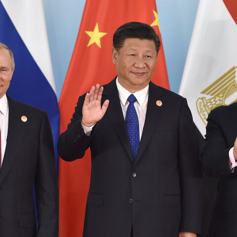 (L-R) Russian President Vladimir Putin, Chinese President Xi Jinping, Egypt's President Abdel-Fattah el-Sisi wave hands during the group photo session, a head of the Dialogue of Emerging Market and Developing Countries, on the sideline of the 2017 BRICS Summit in Xiamen, southeastern China's Fujian Province on Sept. 5, 2017.