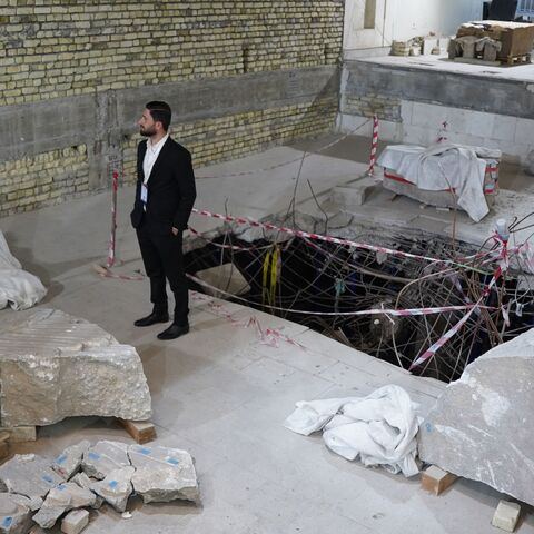 A man looks at artifacts, under restoration after being destroyed by the Islamic State (IS) group, at the Mosul Museum in Iraq's northern city on May 11, 2023.