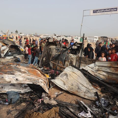 Palestinians gather at the site of an Israeli strike on a camp for internally displaced people in Rafah on May 27, 2024.