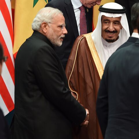 Saudi Arabia's Crown Prince Salman bin Abdulaziz (2nd R) shakes hands with India's Prime Minister Narendra Modi (C) after they joined heads of states and international organizations for a "family photo" during the G20 Summit in Brisbane on Nov. 15, 2014. 