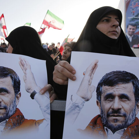 BEIRUT, LEBANON - OCTOBER 13: Lebanese people wave flags and hold portraits of Iranian President Mahmoud Ahmadinejad (not pictured) as he arrives in southern suberb of Beirut on October 13, 2010 in Lebanon. The controversial visit is seen as a boost for key ally Hezbollah. According to reports Mr Ahmadinejad may visit the border with Israel - the site of recent deadly clashes between Israeli and Lebanese forces. (Photo by Salah Malkawi/Getty Images)