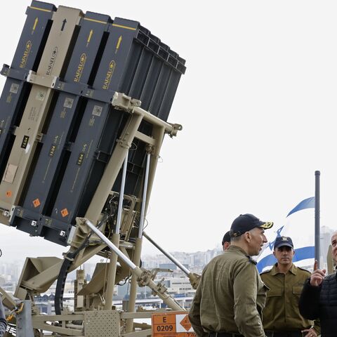 A picture taken on February 12, 2019, shows Israeli Prime Minister Benjamin Netanyahu (R) discussing with soldiers as he stands near a naval Iron Dome defence system, designed to intercept and destroy incoming short-range rockets and artillery shells, installed on a Sa'ar 5 Lahav Class corvette of the Israeli Navy fleet, in the northern port of Haifa. (Photo by JACK GUEZ / POOL / AFP) (Photo credit should read JACK GUEZ/AFP via Getty Images)