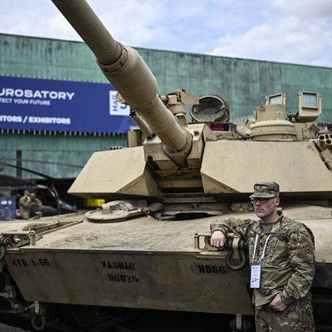 US marines lean on a Abraham tank during the Eurosatory international land, air defence and security trade fair, in Villepinte, a northern suburb of Paris, on June 17, 2024. 