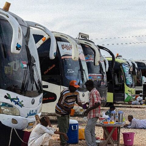 Sudanese drivers rest on May 14, 2023 after transporting evacuees from Sudan into Egypt, in Wadi Karkar village near Aswan.