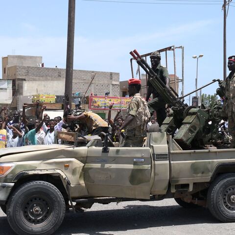 Sudanese greet army soldiers, loyal to army chief Abdel Fattah al-Burhan, in the Red Sea city of Port Sudan on April 16, 2023. 