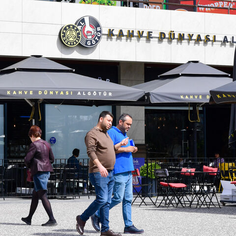 Shoppers walk past a coffee shop at a shopping mall in Ankara, Turkey on April 2, 2024. 