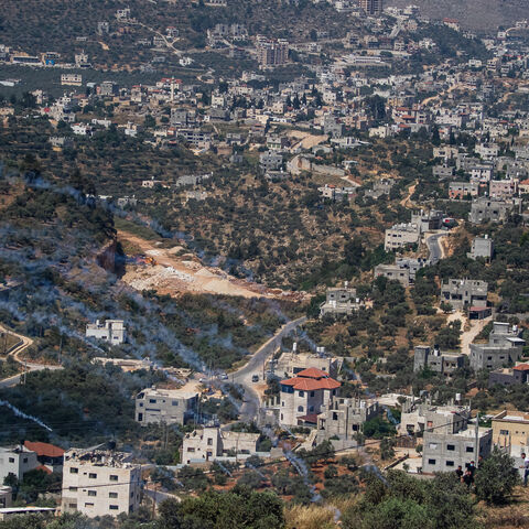 A view of Beita town with smoke from the teargas cannister fired by Israeli soldiers during an intervention in the clashes between Palestinians and Israeli settlers who stormed the top of Mount Al-Arma in Beita town, south of Nablus on Friday, May 03, 2024. The tensions have been rising in the areas of West Bank between the Palestinians and Israelis since October 07, and often the Israeli police intervene by firing teargas, and sending armed forces to disperse the Palestinians gathered to confront the Israe