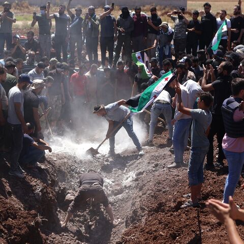 Syrians attend the burial of a man killed during clashes with Turkish troops, in Afrin in northern Syria on July 2, 2024.