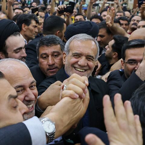 Supporters cheer as newly elected Iranian President Masoud Pezeshkian arrives at the shrine of the Islamic Republic's founder Ayatollah Ruhollah Khomeini in Tehran on July 6, 2024. 