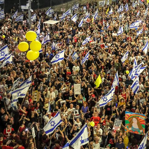 Israeli anti-government protesters prepare to release yellow balloons during a demonstration demanding action to release the hostages taken captive by Palestinian militants in the Gaza Strip in the Oct. 7 attacks, central Tel Aviv, July 6, 2024.