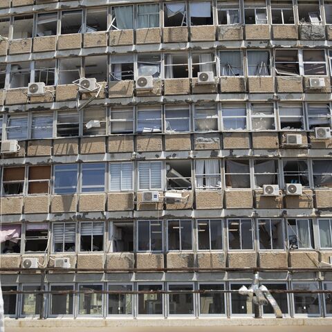  A man looks at a building damaged by a drone explosion that Houthis rebels in Yemen claimed responsibility for, Tel Aviv, July 19, 2024.