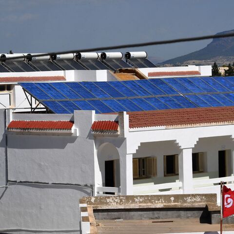 Solar pannels cover the rooftops of the buildings of the Makhtar boarding school on September 29, 2022, in the Tunisian central-west region of the same name. - The Makthar boarding school, a unique business initiative is both generating income and opening pupils' minds to the outside world. Lotfi Hamadi, founder of the NGO "Wallah (Swear to God) We Can", is hoping that helping schools boost their resources through food and energy production can breathe new life into Tunisia's failing, cash-strapped educatio