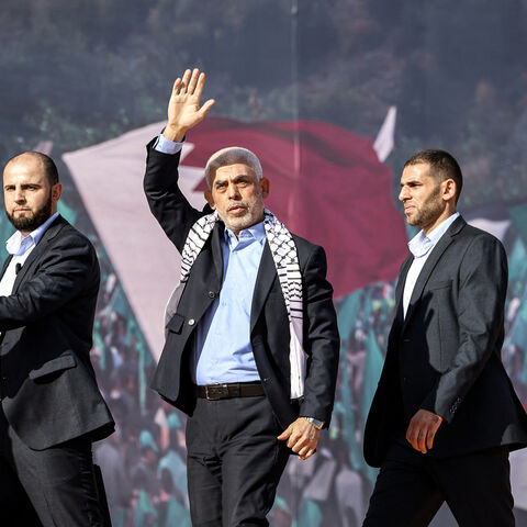 Yahya al-Sinwar (C), Gaza Strip chief of the Palestinian Islamist Hamas movement, waves to supporters during a rally marking the 35th anniversary of the group's foundation, in Gaza City on December 14, 2022. Hamas will end talks on securing a prisoner exchange with Israel unless there is progress soon, the militant group's leader in the Gaza Strip said on December 14. Since Israel's 2014 invasion of the Gaza Strip, the Islamist group has held the bodies of Israeli soldiers Oron Shaul and Hadar Goldin, altho