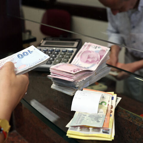 A customer buys US dollars in exchange for Turkish lira at an exchange office in Ankara, Turkey, July 20, 2023.