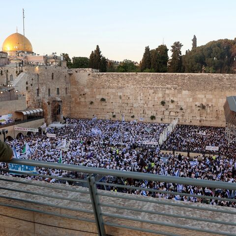 An armed Israeli soldier watches nationalists gathered at the Western Wall in the Old City of Jerusalem on June 5, 2024, during the so-called Jerusalem Day flag march.