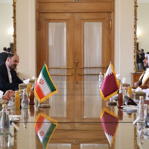 Iran's new foreign minister, Abbas Araghchi (L), meets with Qatari Prime Minister Sheikh Mohammed bin Abdulrahman Al Thani (R) in Tehran, on Aug. 26, 2024.