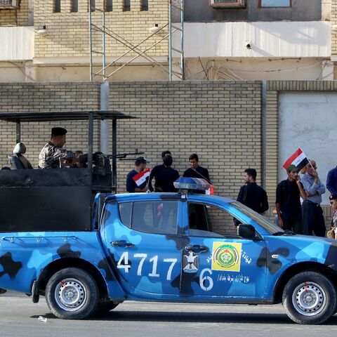 Iraqi security forces monitor the area during a demonstration to demand the withdrawal of the Turkish troops from the Bashiqa camp, located in the Mosul province, on Oct. 8, 2016, outside the Turkish Embassy in Baghdad. 