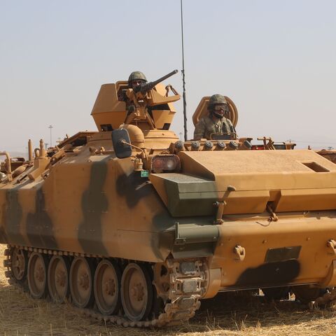 A soldier rides on a Turkish armored vehicle near the Habur crossing gate between Turkey and Iraq during a military drill on September 18, 2017. 