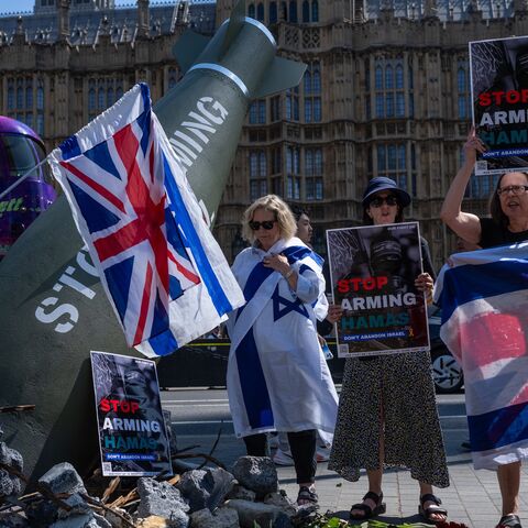 Pro-Israel demonstrators stage a counterprotest around an Oxfam installation.